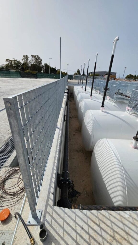 Row of above-ground horizontal fuel tanks behind security fence #2