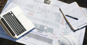 Engineer reviewing building plans on a tablet for the Building Identity Certificate